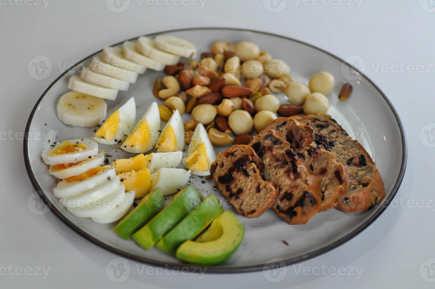 walnut cranberry sourdough bread or cranberry sourdough with boiled egg , avocado , banana and nuts photo