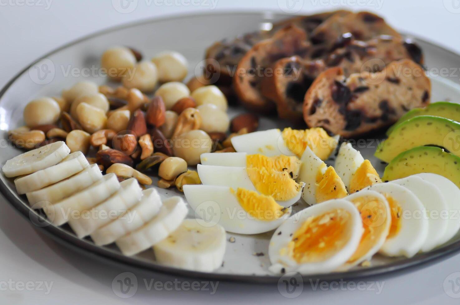walnut cranberry sourdough bread or cranberry sourdough with boiled egg , avocado , banana and nuts photo