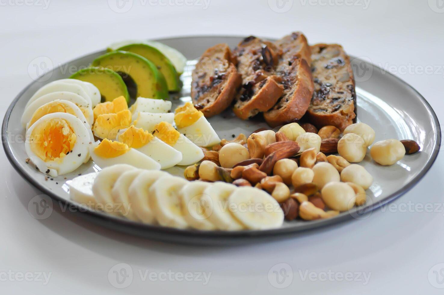 walnut cranberry sourdough bread or cranberry sourdough with boiled egg , avocado , banana and nuts photo