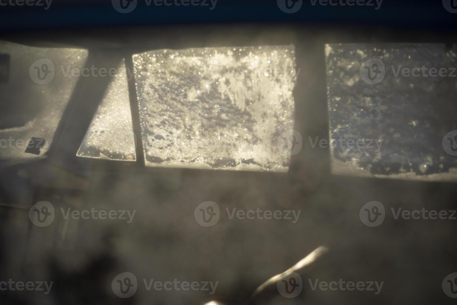 Frozen glass. Ice on the window. Snowflakes on the surface. photo