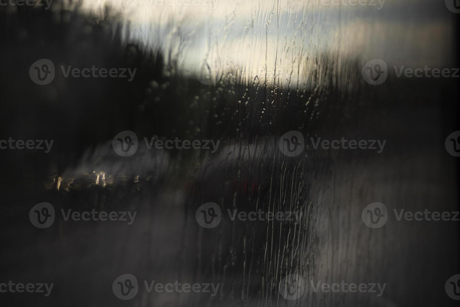 Wet glass. Jets of rain on the glass. Spray on the window. Rain on the street. photo