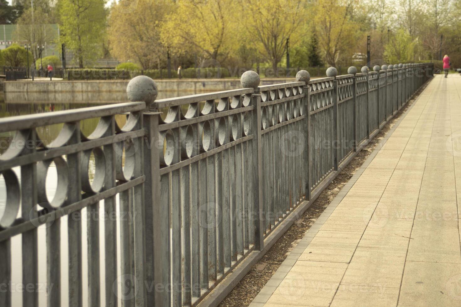 Fence on the lake. Park details. Old fence. photo