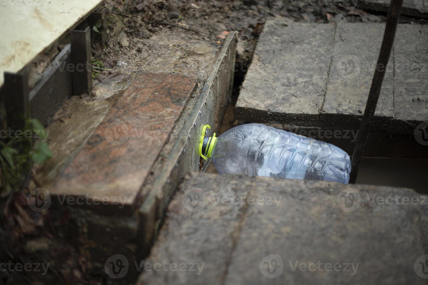 Spring water. Water from a source. Bottle with a pipe. photo