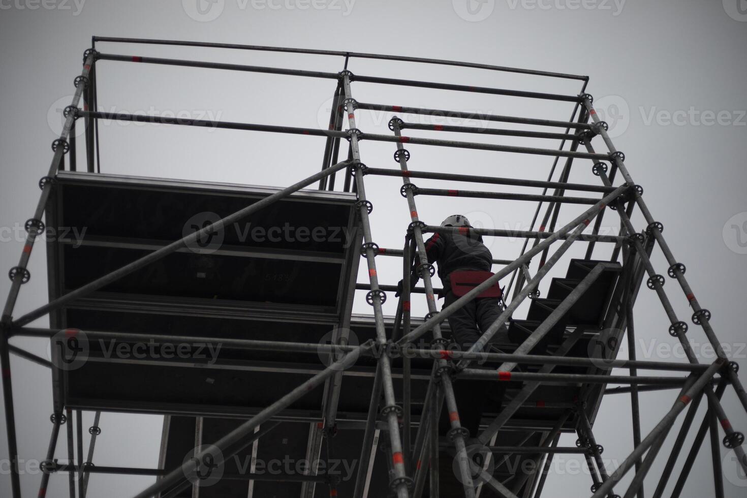 Workers on scaffolding. Construction of the structure. Installers in the process of work. photo
