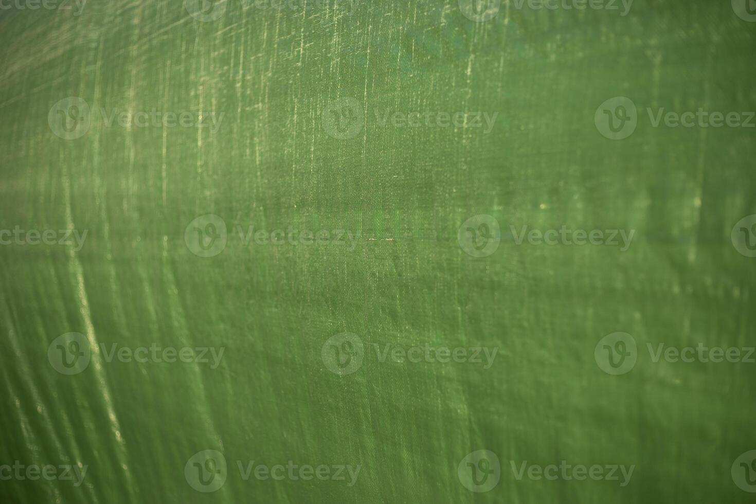 Green awning. Plastic fabric texture. Light on the surface. photo