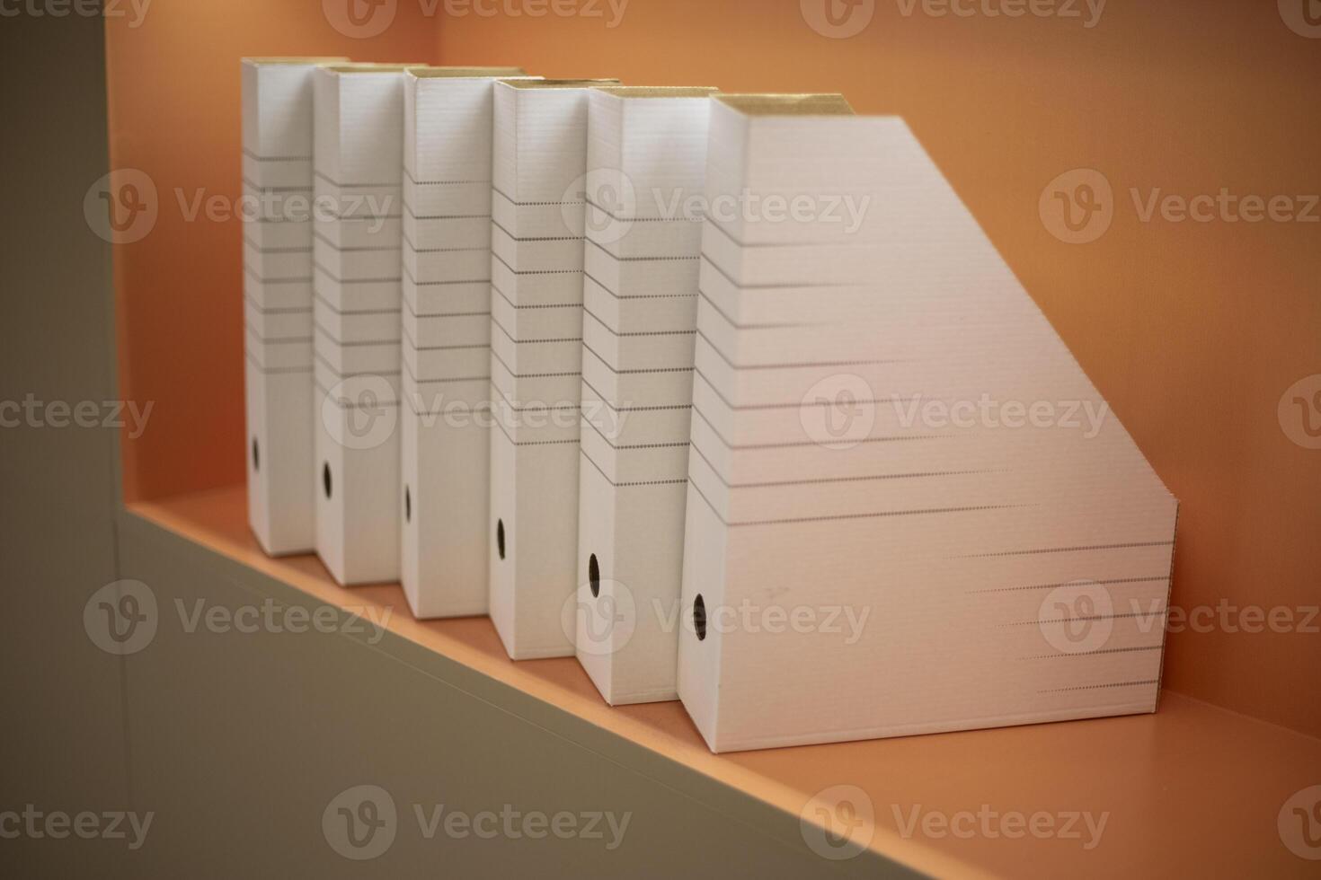 Empty folders stand in a row. A place to store documents. Folders on the shelf. photo