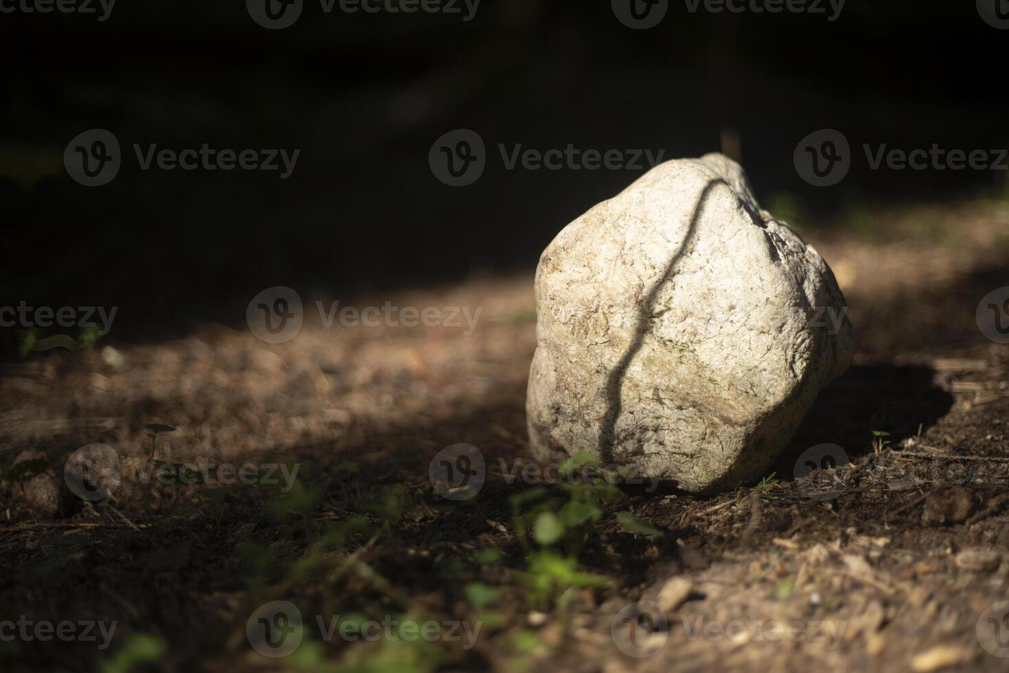 Stones standing on the ground. The light of the sun on a rock. Ancient rocks. photo