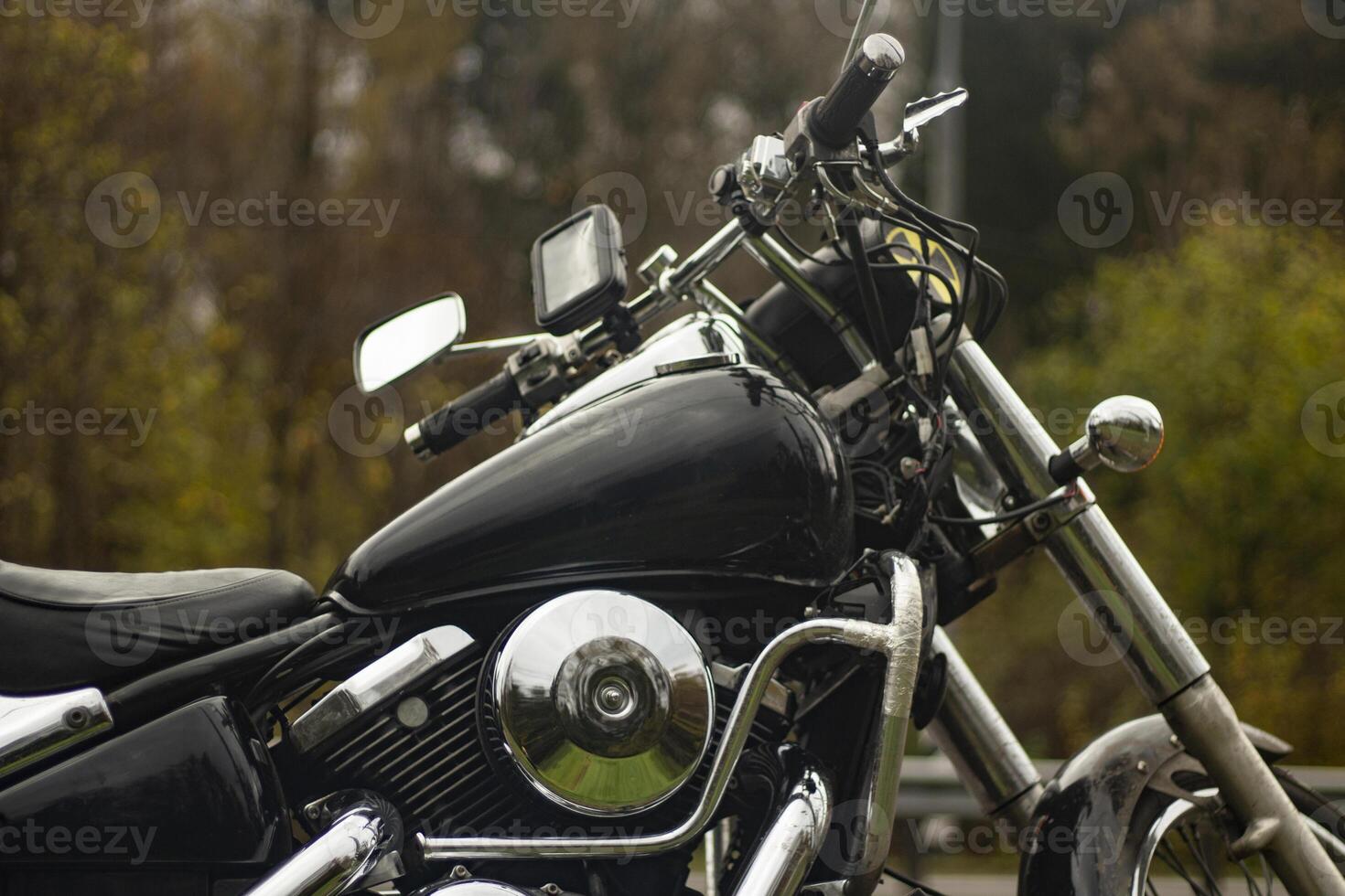 Black motorcycle on the side of the road. A motorcycle without a motorcyclist. Chrome plated parts. photo