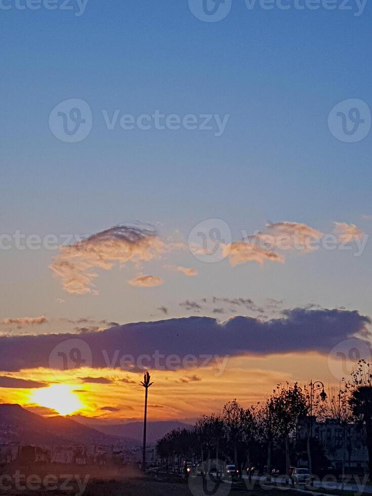 Sunset that creates a picturesque scene, where the warm hues of the setting sun cast a golden glow photo