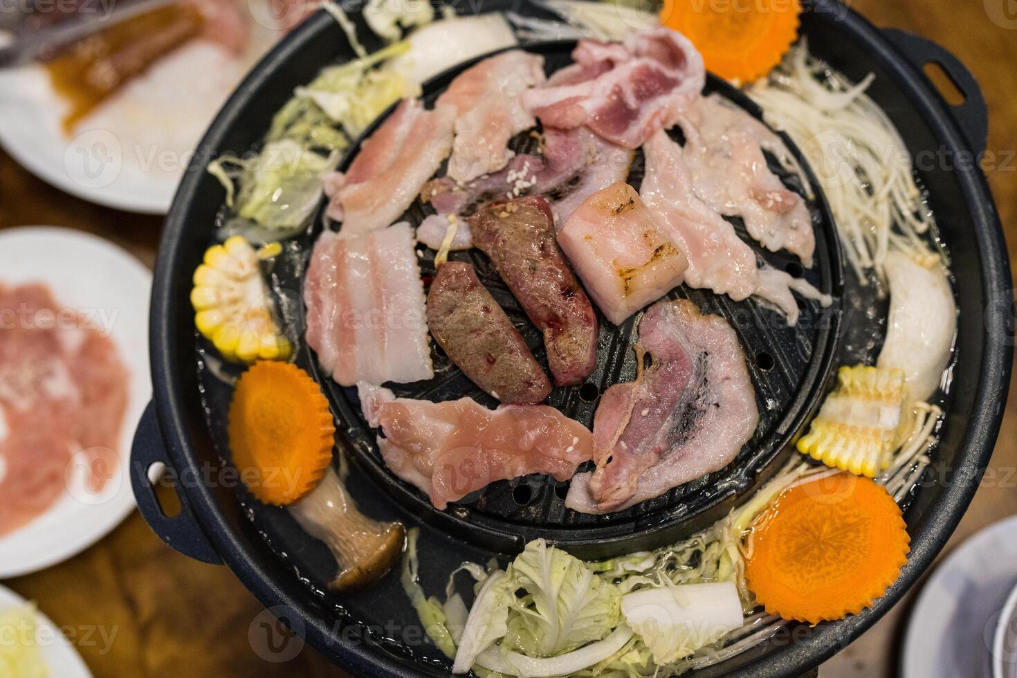 Meat or sea food on the hot pan that can put the soup of vegetable around a pan too. Moo Grata photo