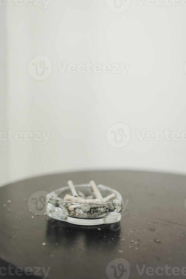 Cigarette butts in an ashtray photo