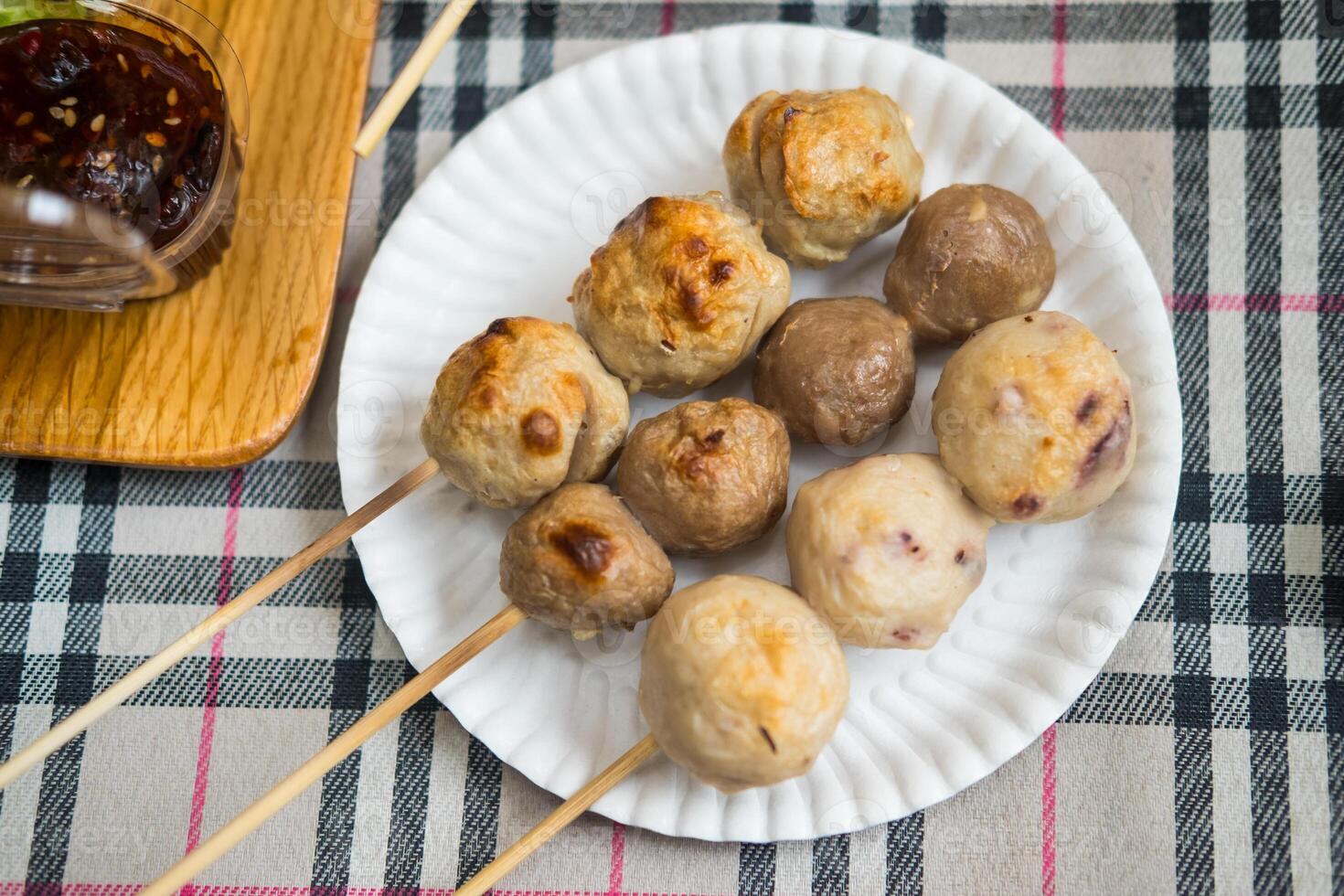 Three skewers grilled of meatballs include porkball, squidball and beefball on skewers photo