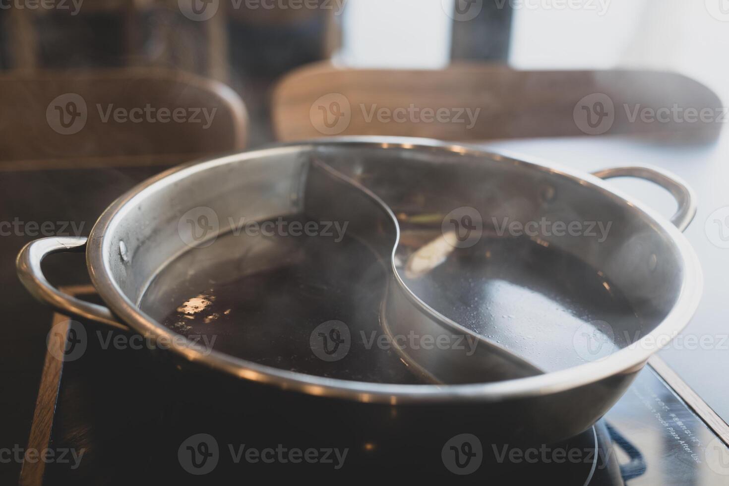 Combo pot for two flavors of hot pot soup base photo