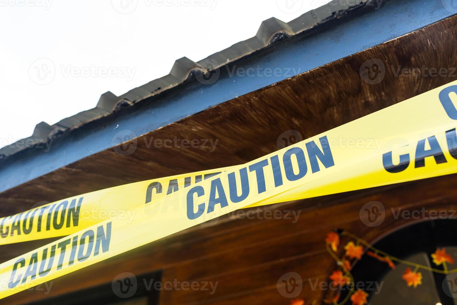 Caution yellow tape. Do not enter. Yellow caution tape on the home at daytime. photo