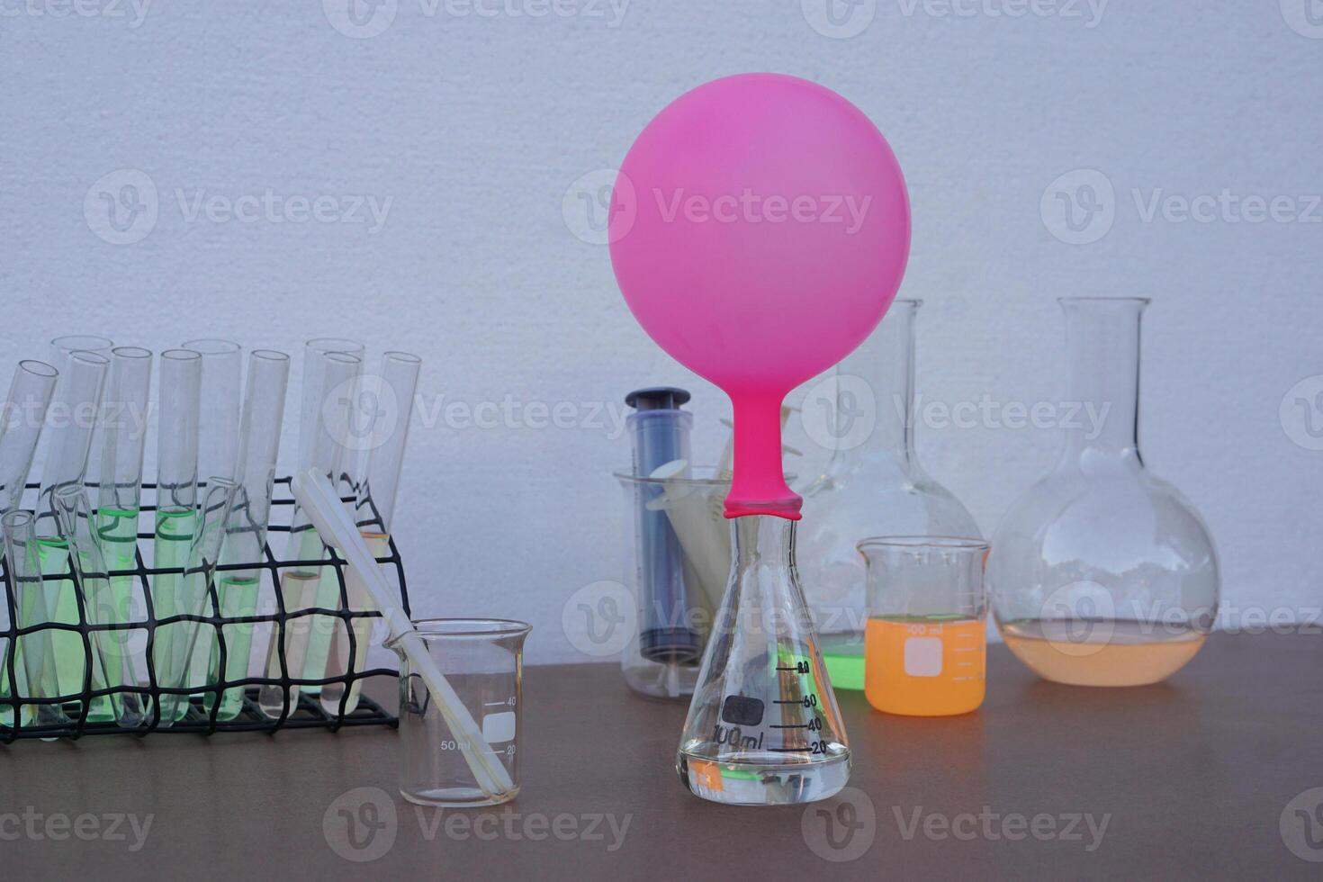Science experiment , pink inflated balloon on top of transparent test bottle. The experiment about air or gas reaction by using baking soda and vinegar. Concept, Science Education photo