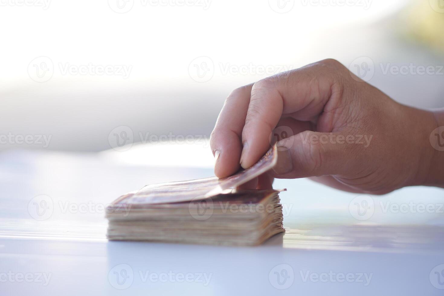Close up hand holds paper card up from deck. Concept, play card. Recreational activity. Free time and hobby. Fortune reading from cards. Prediction for future life ,events. Astrology. Foretelling. photo