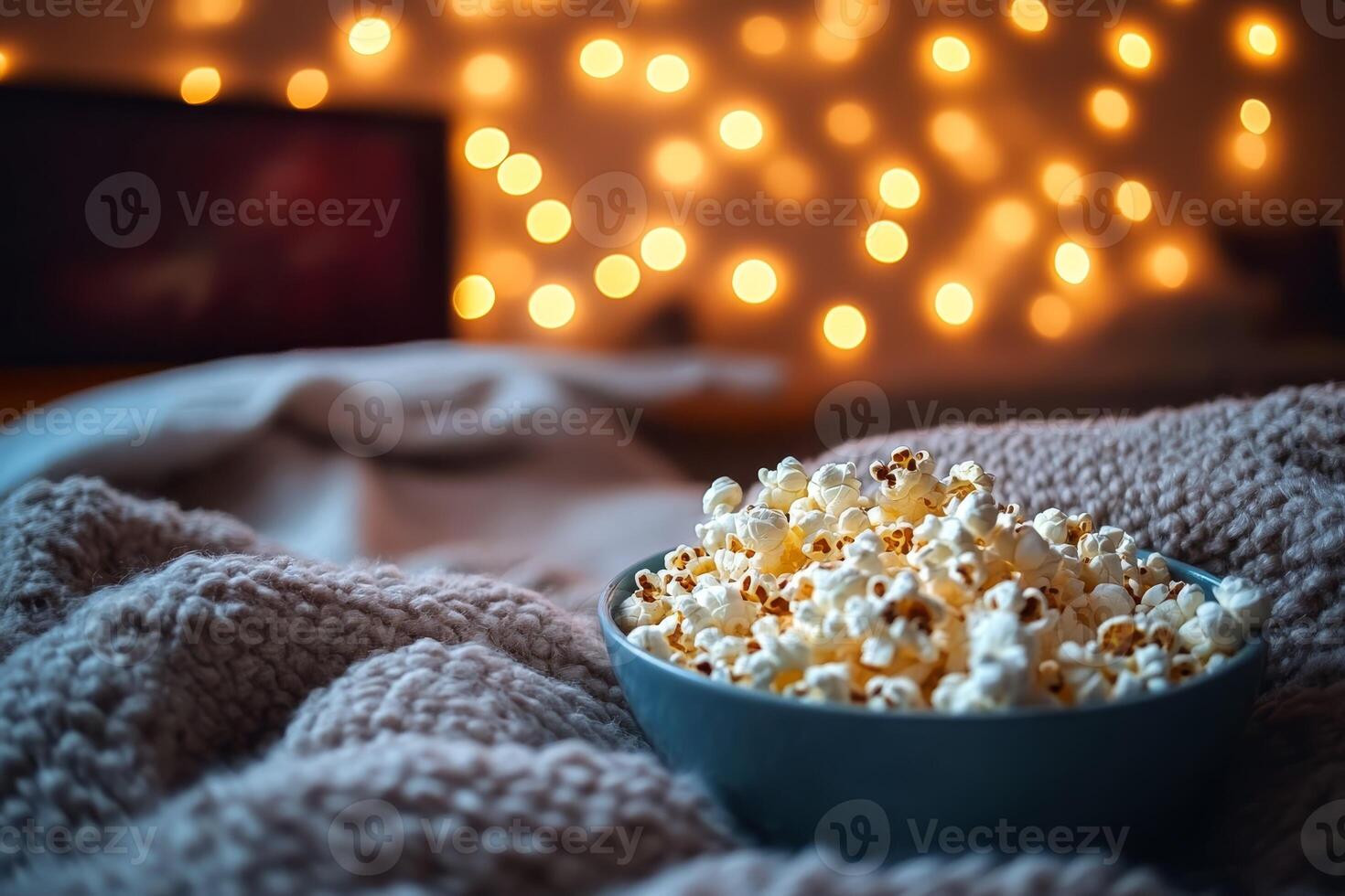 Picture a cozy living room, perfect for movie night, featuring a bowl of popcorn, soft blankets, and twinkling lights that create a relaxing atmosphere for enjoying a film with loved ones photo