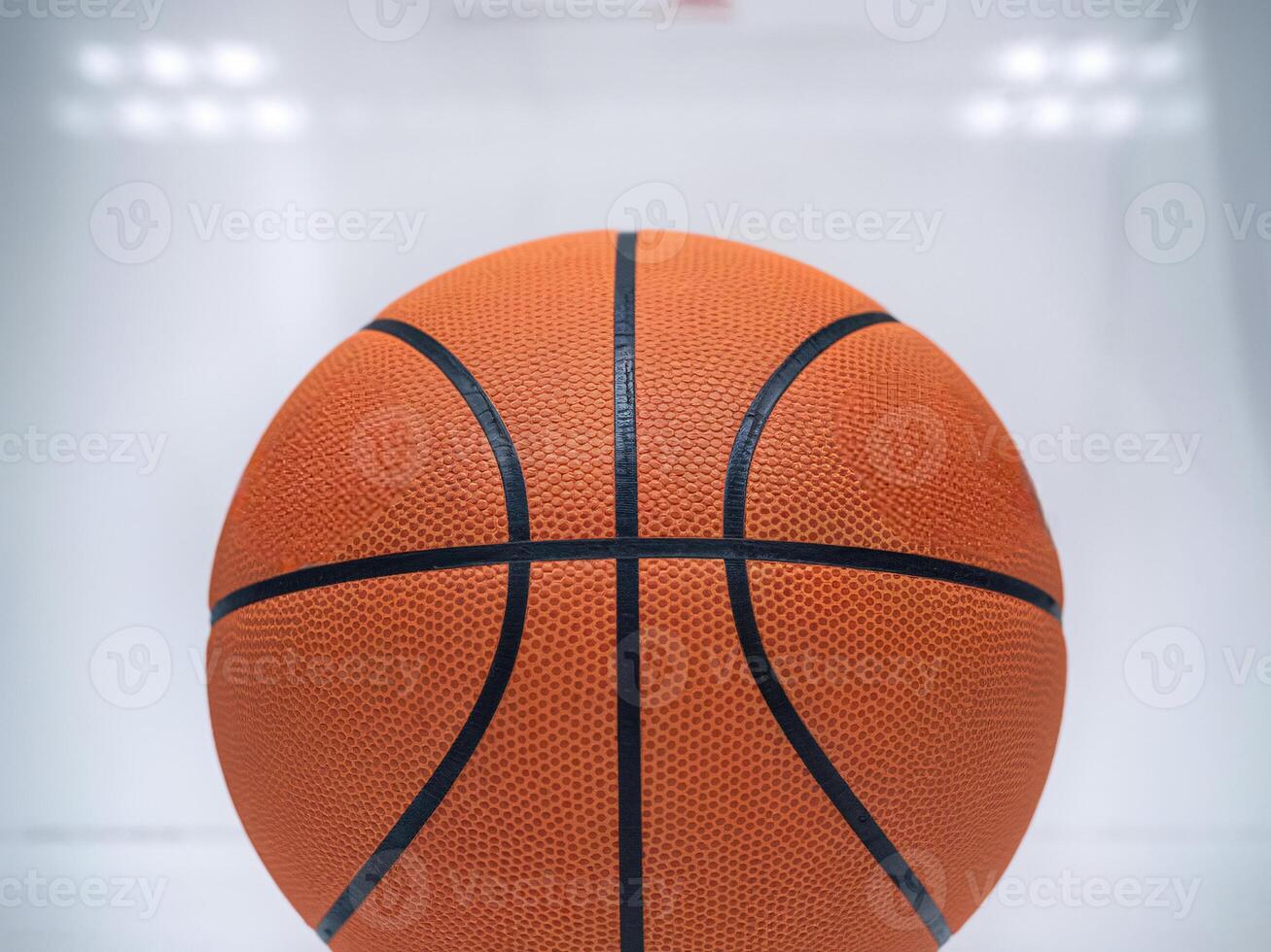 Close-up of a textured orange basketball on a bright background. photo