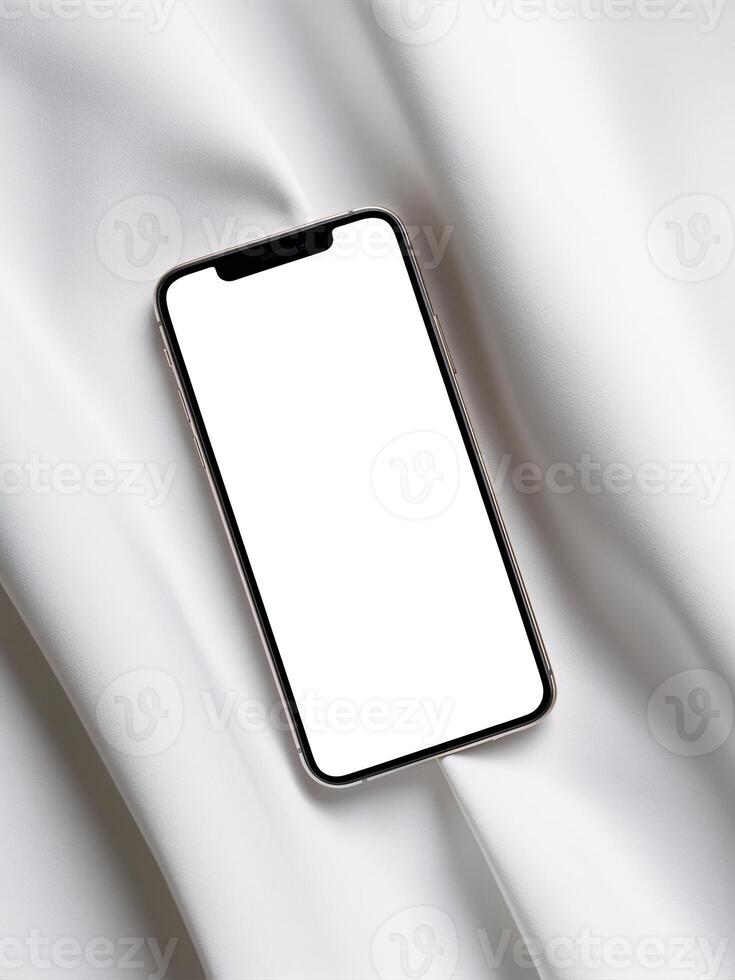 A sleek smartphone resting on smooth white fabric, showcasing its blank screen. photo