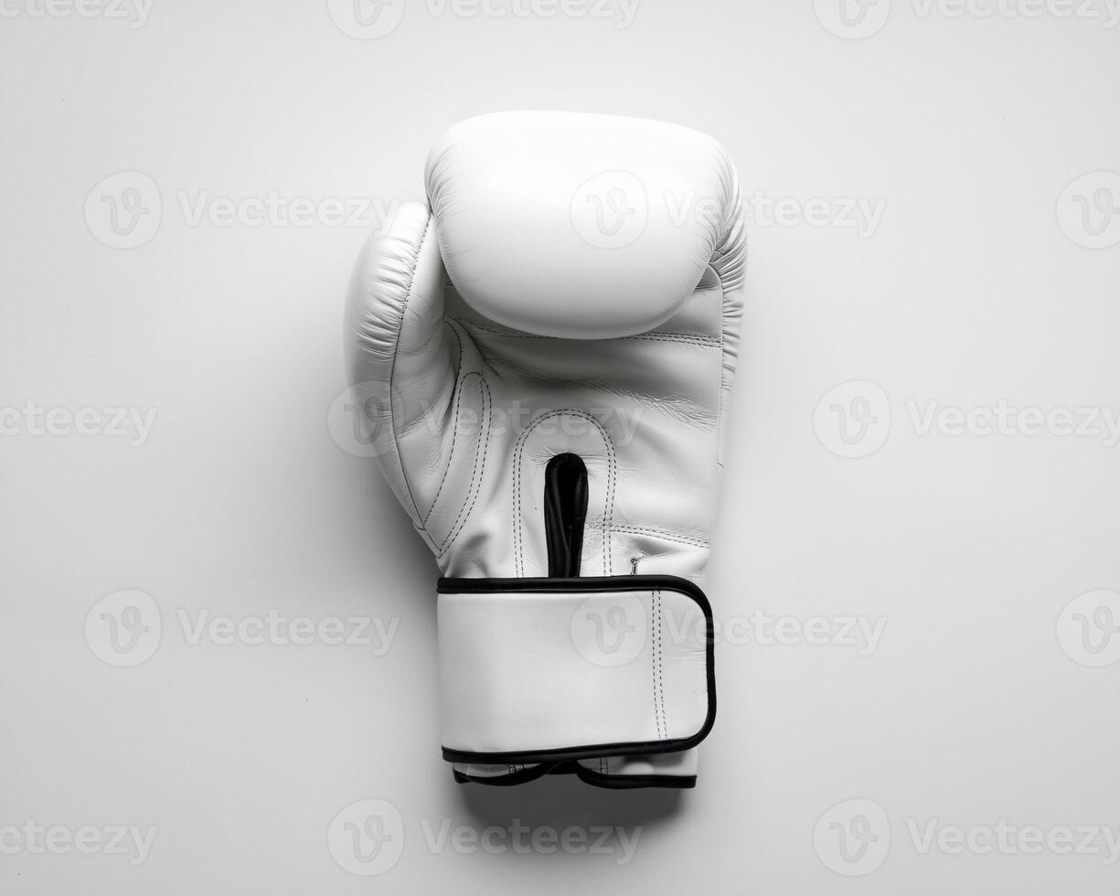 A pristine white boxing glove laid on a clean surface, highlighting its sleek design and craftsmanship. photo