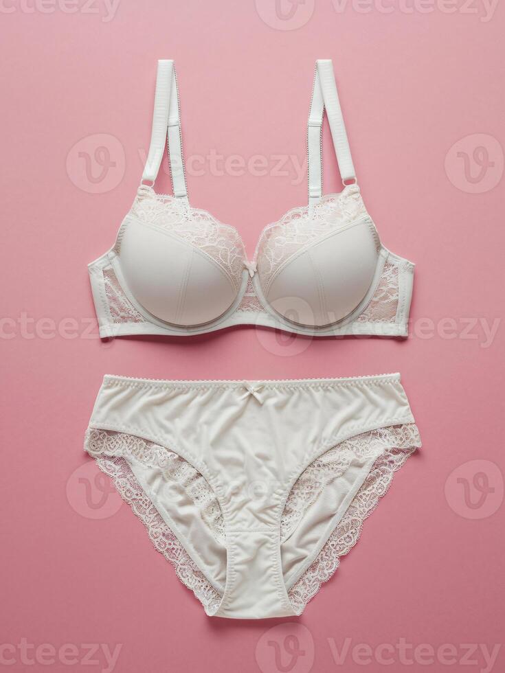 Elegant white lace lingerie set on a soft pink background, showcasing delicate details and feminine charm. photo
