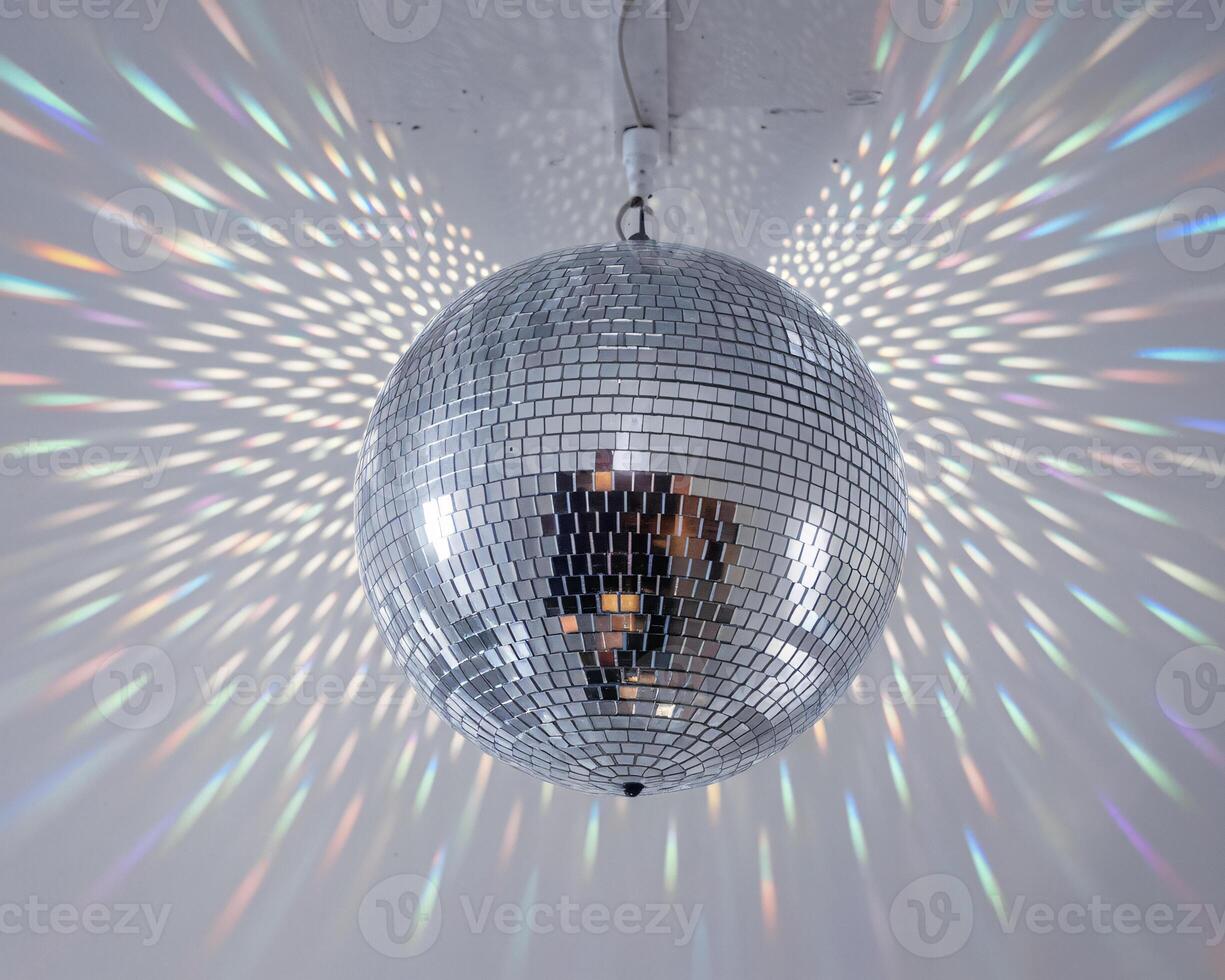 A sparkling disco ball reflecting vibrant light patterns in a lively atmosphere. photo