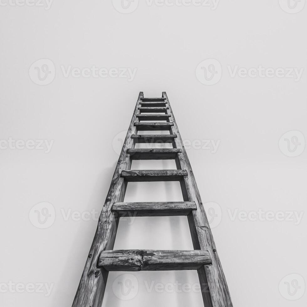 A wooden ladder stretching upward against a minimalistic white background, creating a sense of ascent. photo