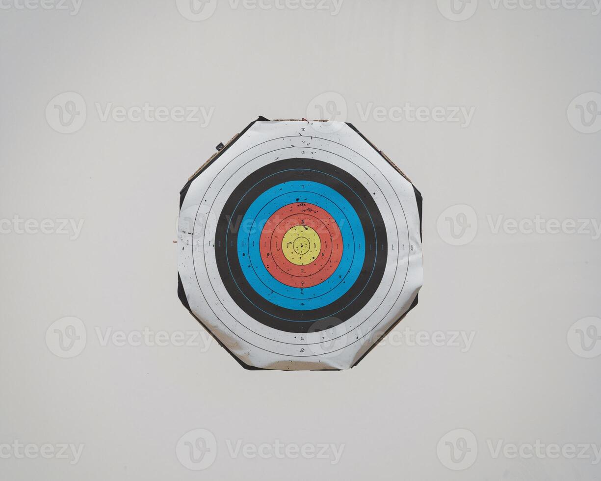 An archery target featuring vibrant colors in a circular pattern, depicting various scoring zones. photo