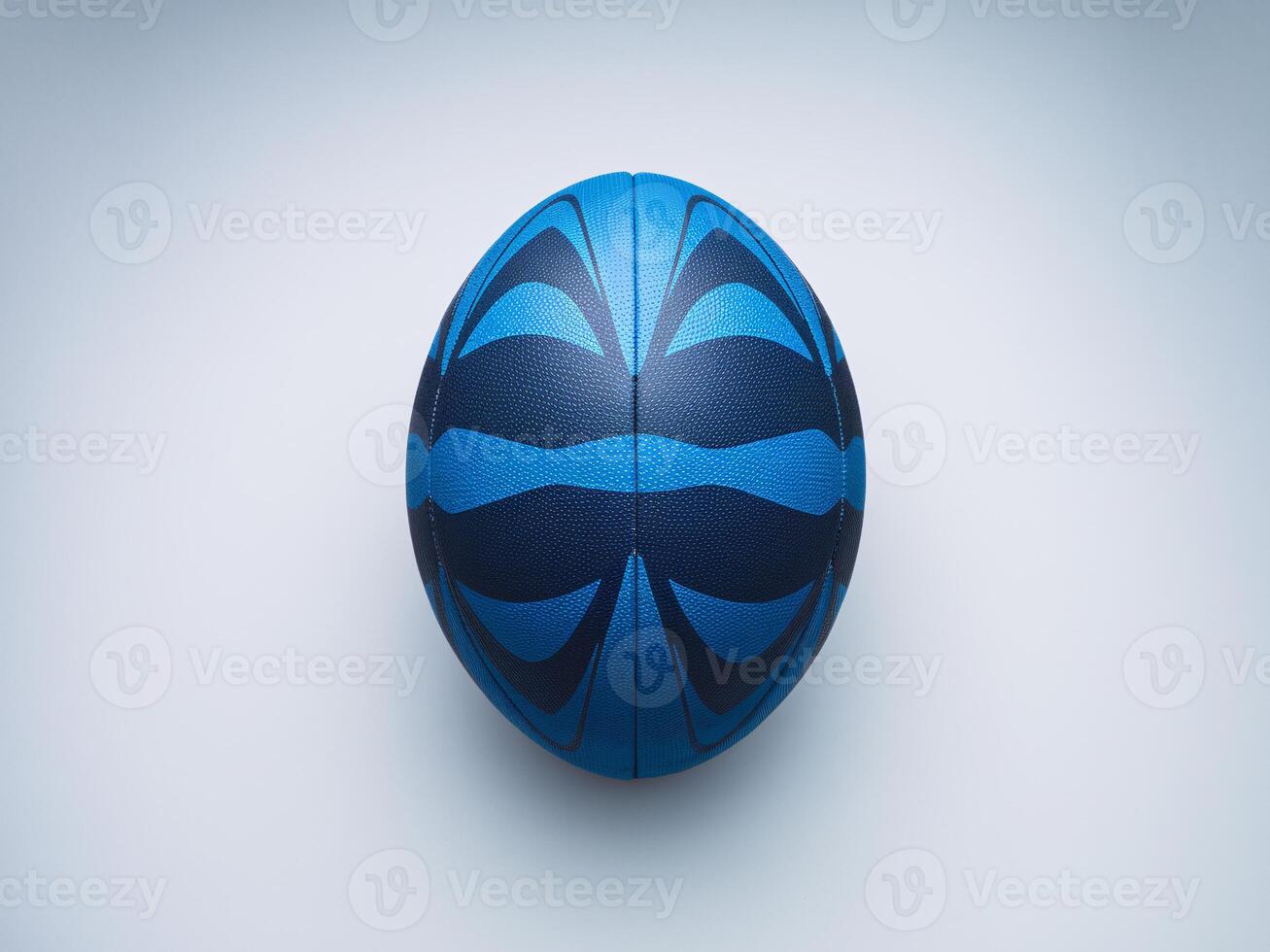 A vibrant blue and black rugby ball resting on a light background, showcasing unique design patterns. photo