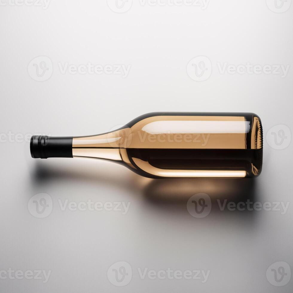 A simple brown glass wine bottle elegantly laid on its side against a soft gray background. photo