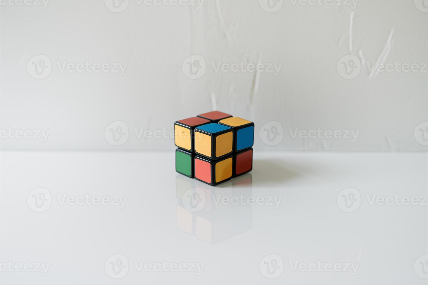 A classic Rubik's Cube on a clean, white surface, showcasing its vibrant colors and intricate design. photo