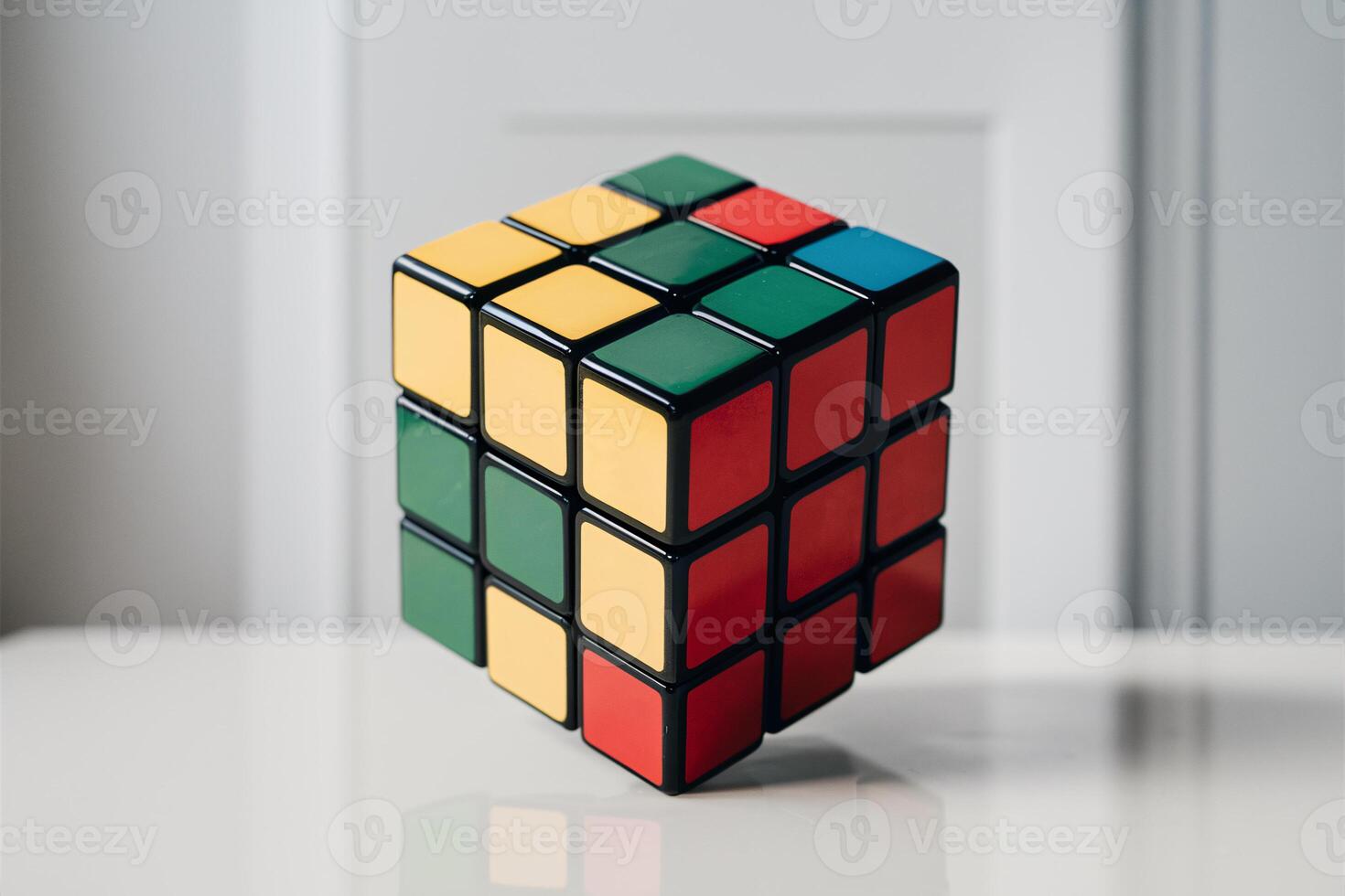 Colorful Rubik's Cube on a reflective surface, showcasing its vibrant sticker arrangement. photo