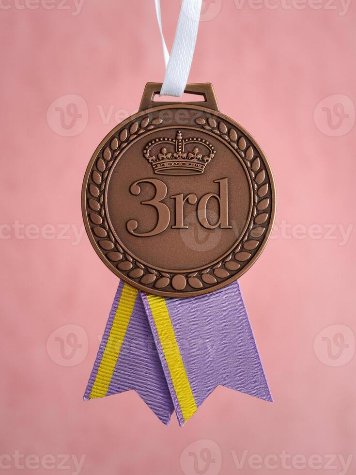 Bronze medal for third place with a decorative ribbon, symbolizing achievement and success. photo