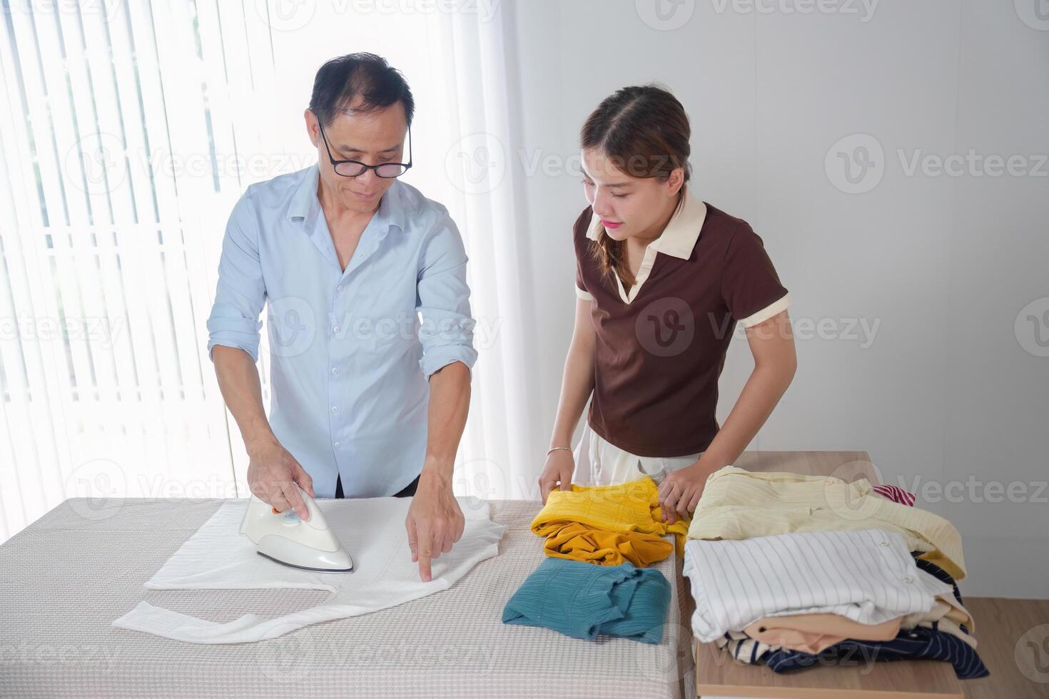 Father Teaching Daughter to Iron Clothes in Modern Home Setting for Family Bonding and Life Skills Learning photo