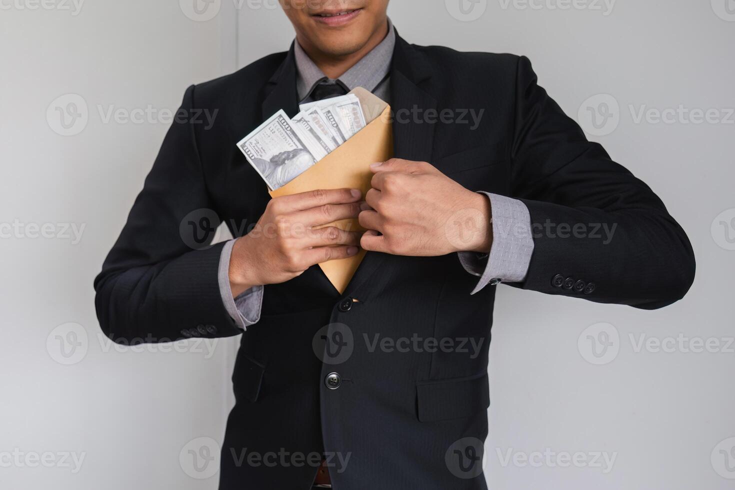 Businessman Hiding Money in Envelope Symbolizing Corruption and Financial Misconduct in Corporate Environment photo