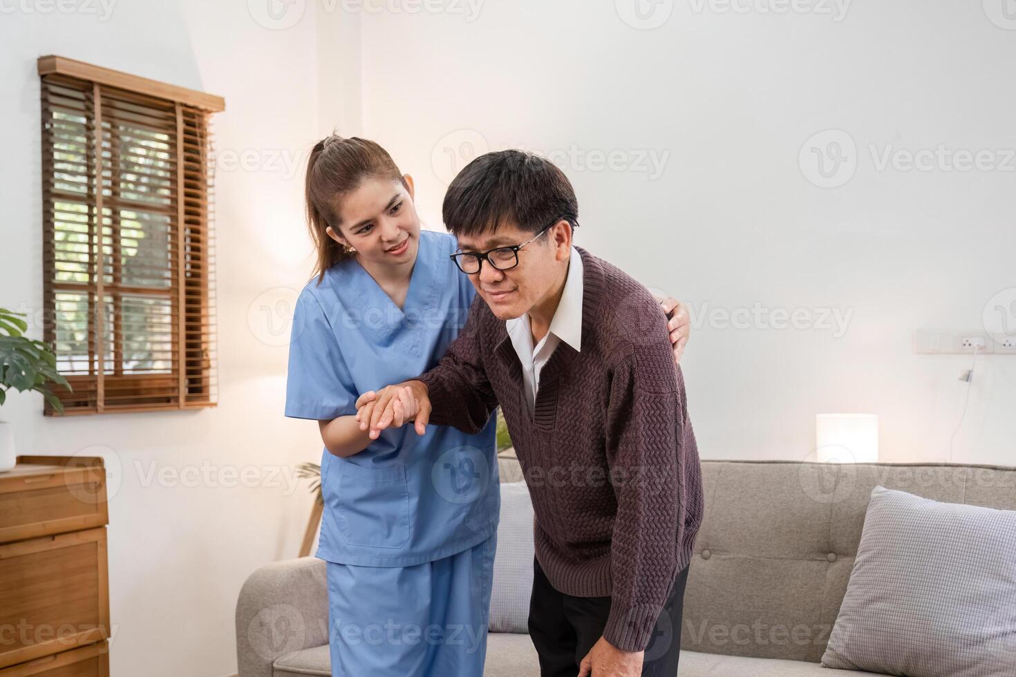 Elderly Caregiver Assisting Retired Man at Home in a Comfortable Living Room Setting for Daily Support and Companionship photo