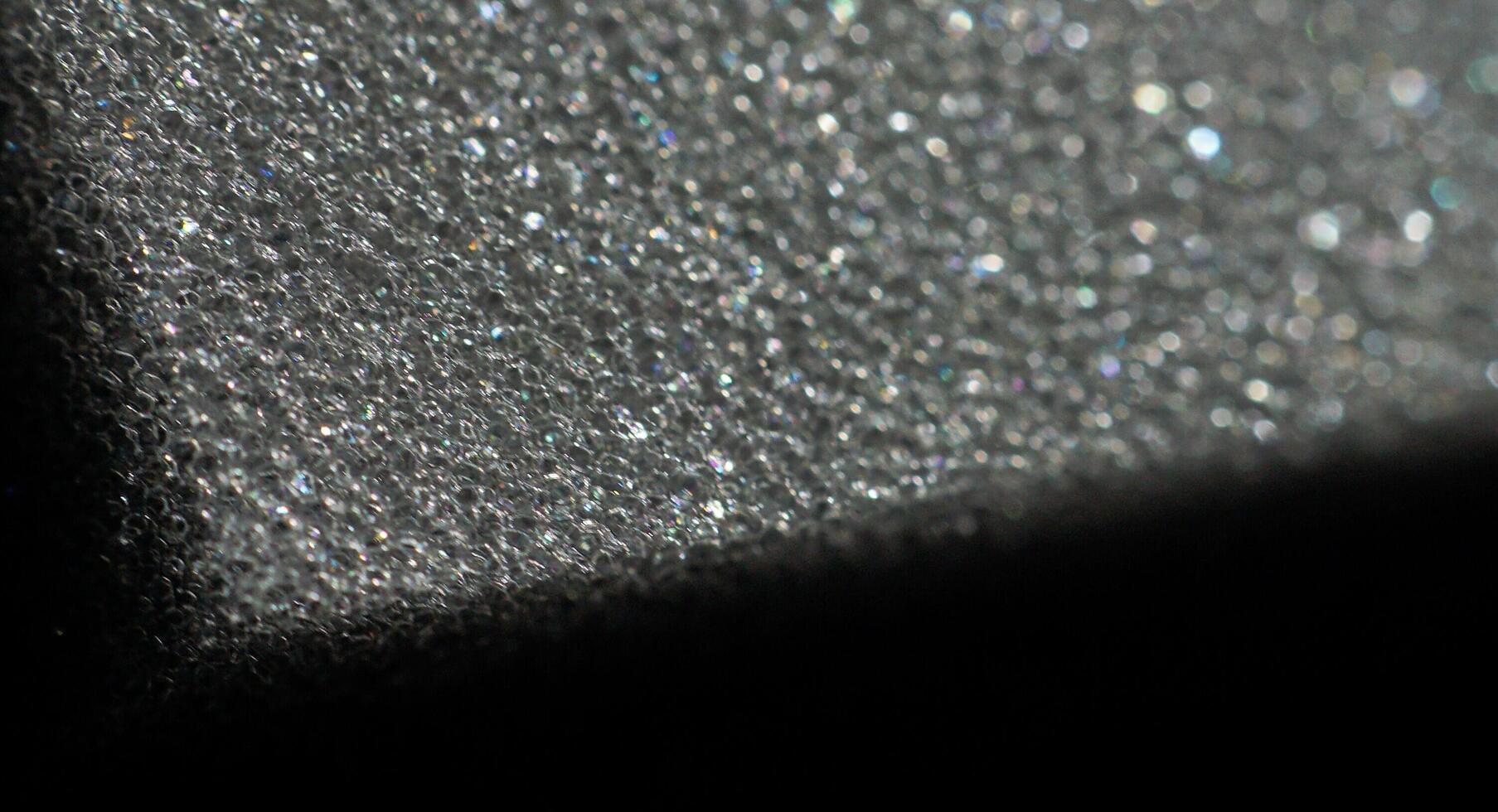 a close up of a piece of glass with a lot of bubbles photo