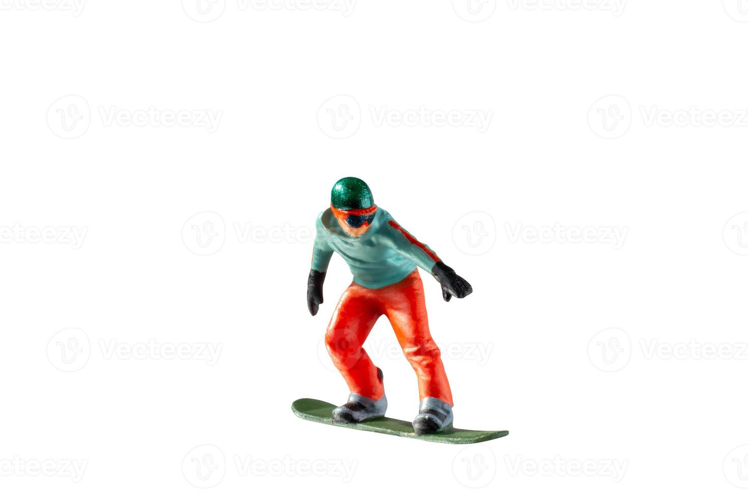 Miniature figurine depicting a snowboarder in mid-motion isolate on white background with clipping path photo