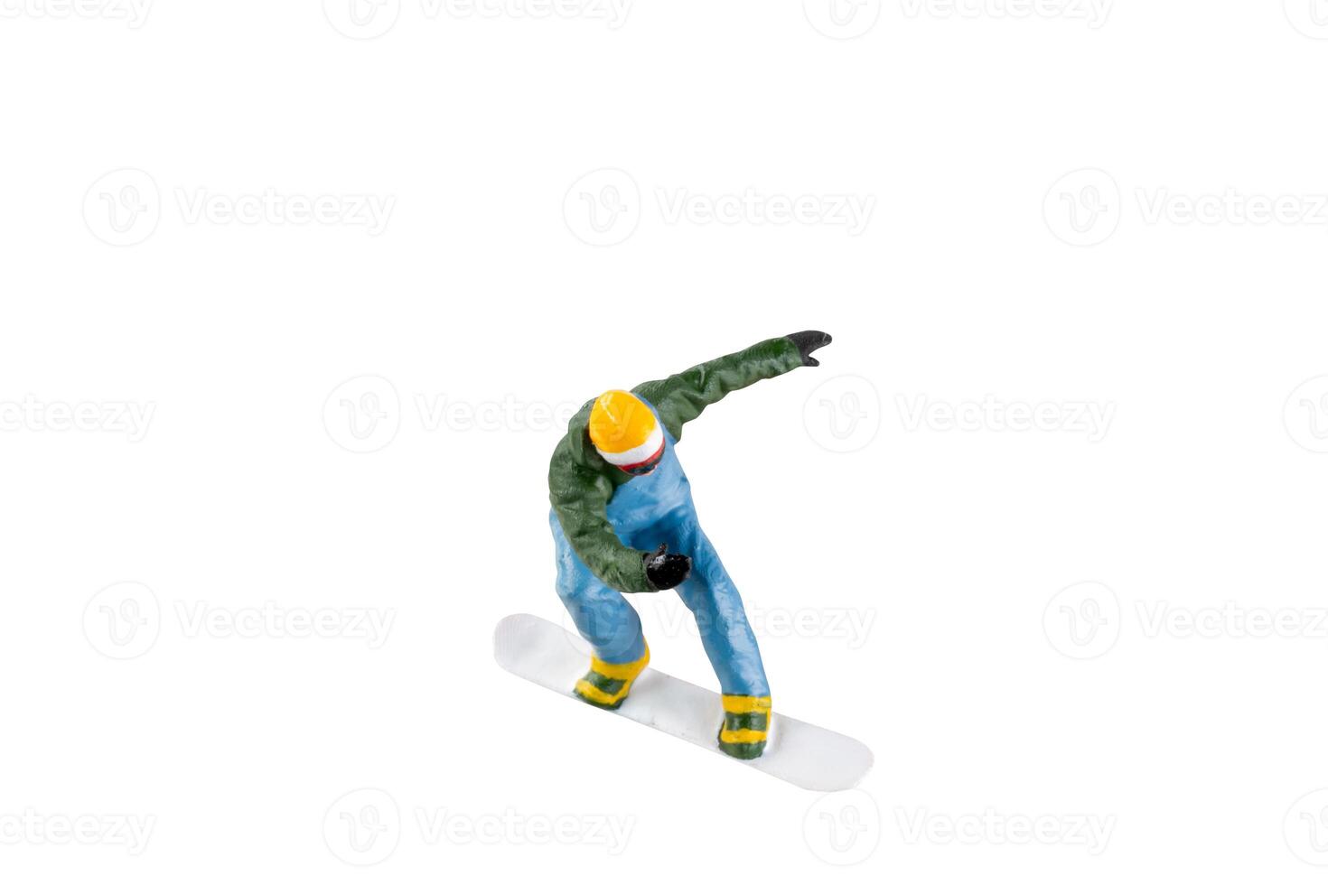 Miniature figurine depicting a snowboarder in mid-motion isolate on white background with clipping path photo