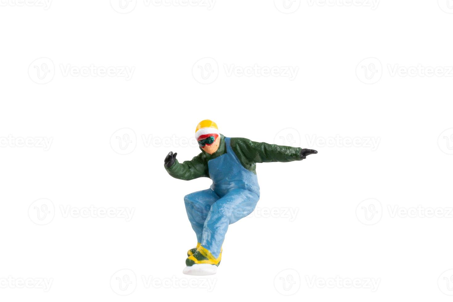 Miniature figurine depicting a snowboarder in mid-motion isolate on white background with clipping path photo