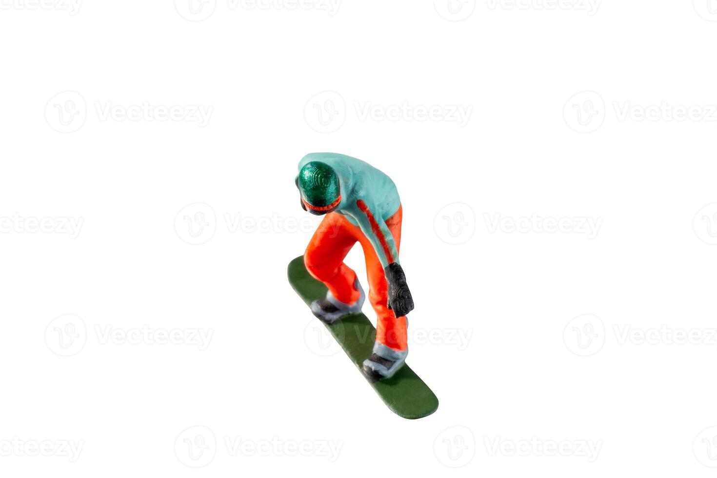 Miniature figurine depicting a snowboarder in mid-motion isolate on white background with clipping path photo
