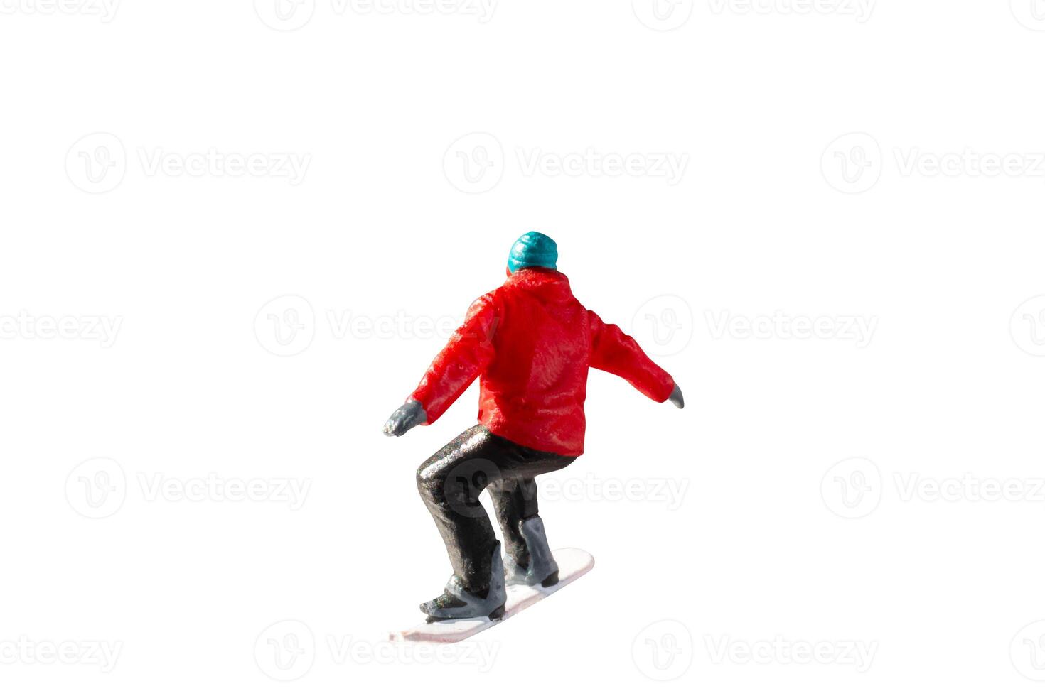 Miniature figurine depicting a snowboarder in mid-motion isolate on white background with clipping path photo