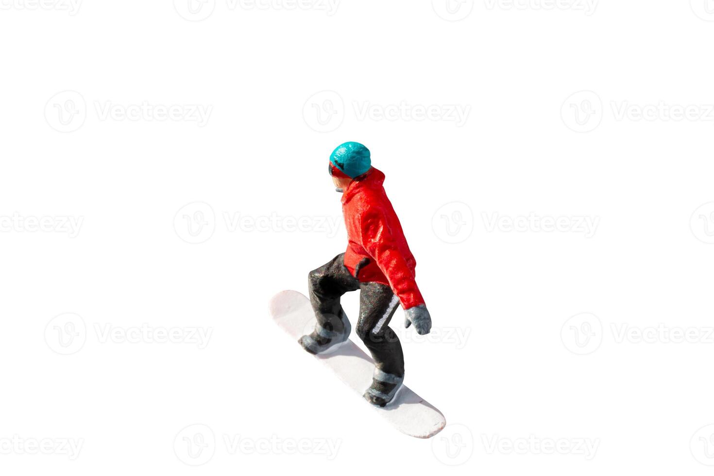 Miniature figurine depicting a snowboarder in mid-motion isolate on white background with clipping path photo