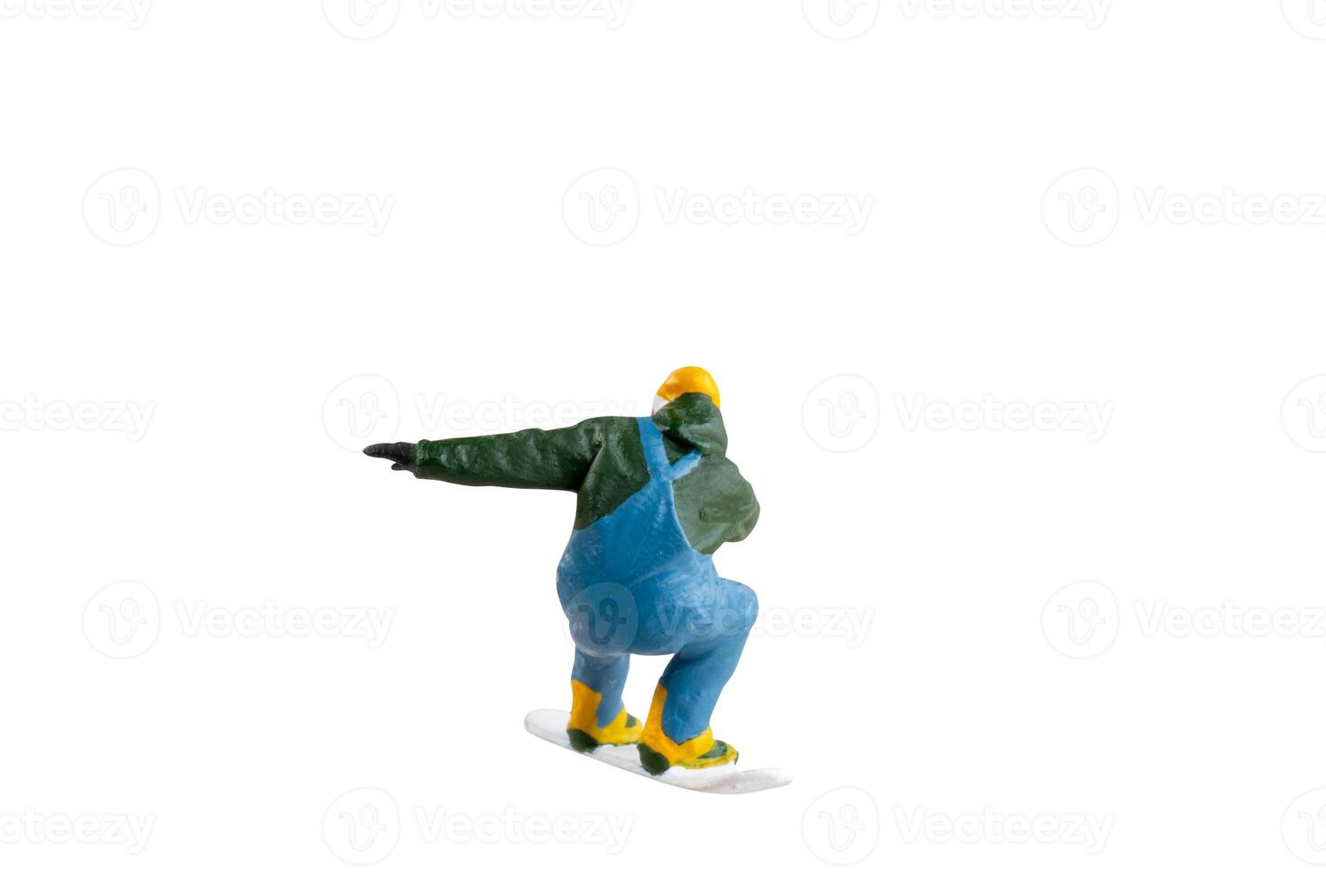 Miniature figurine depicting a snowboarder in mid-motion isolate on white background with clipping path photo