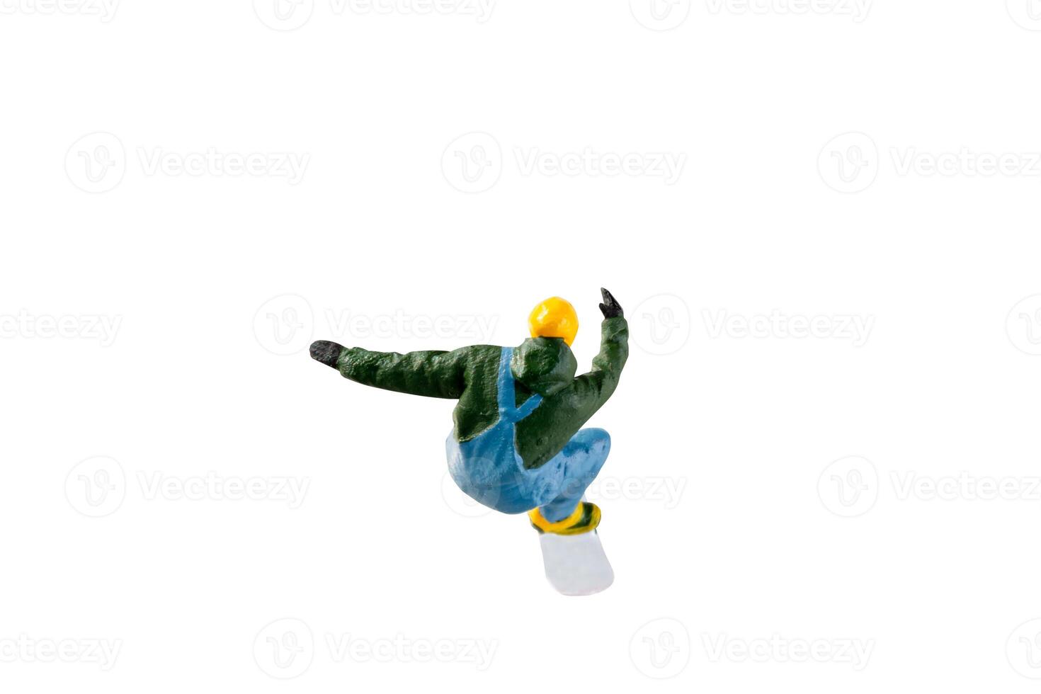 Miniature figurine depicting a snowboarder in mid-motion isolate on white background with clipping path photo