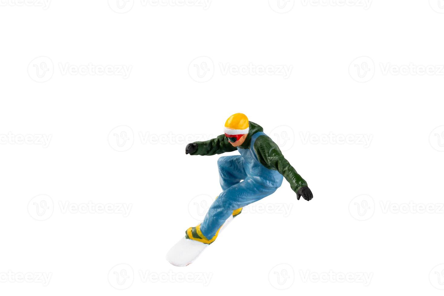 Miniature figurine depicting a snowboarder in mid-motion isolate on white background with clipping path photo