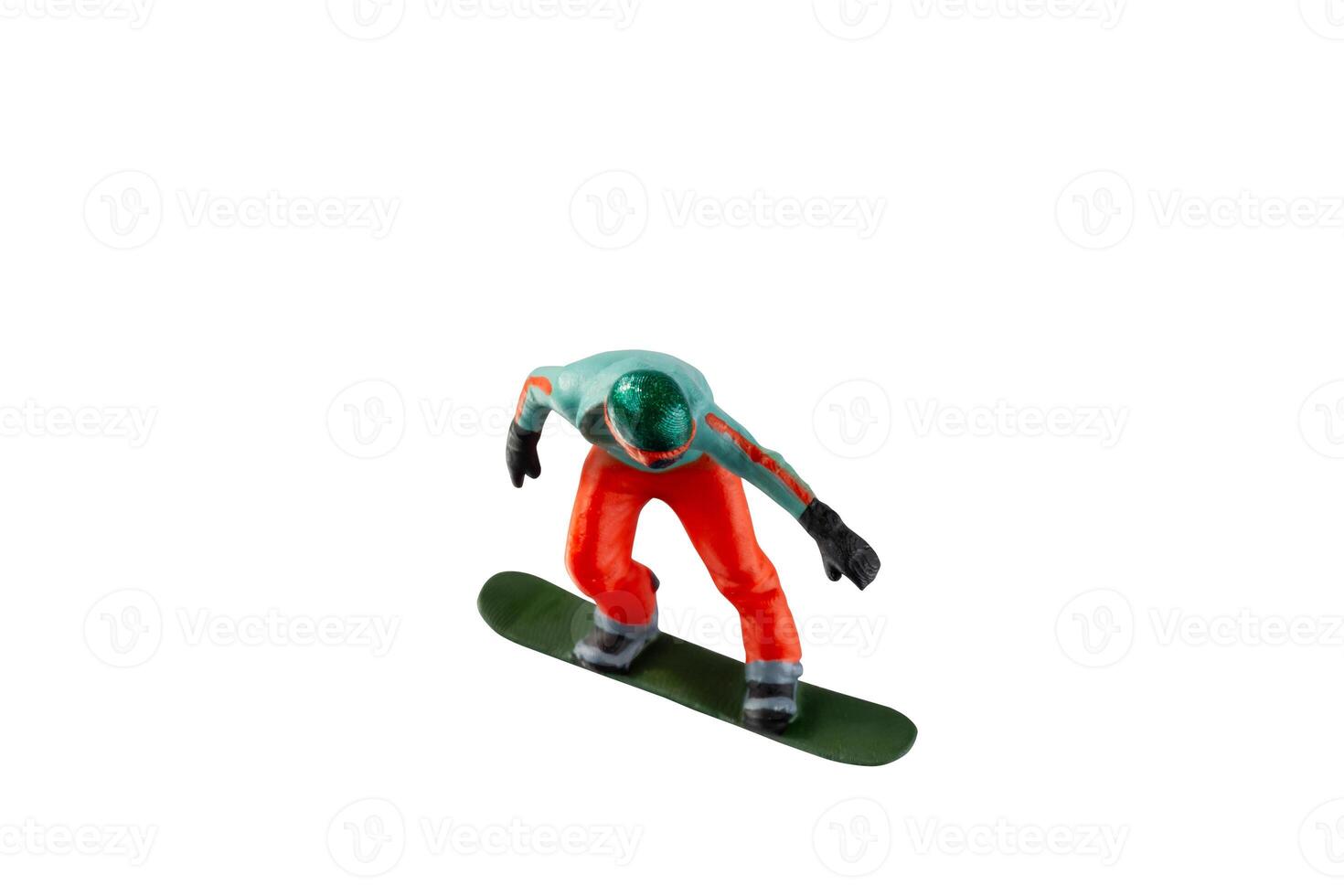 Miniature figurine depicting a snowboarder in mid-motion isolate on white background with clipping path photo