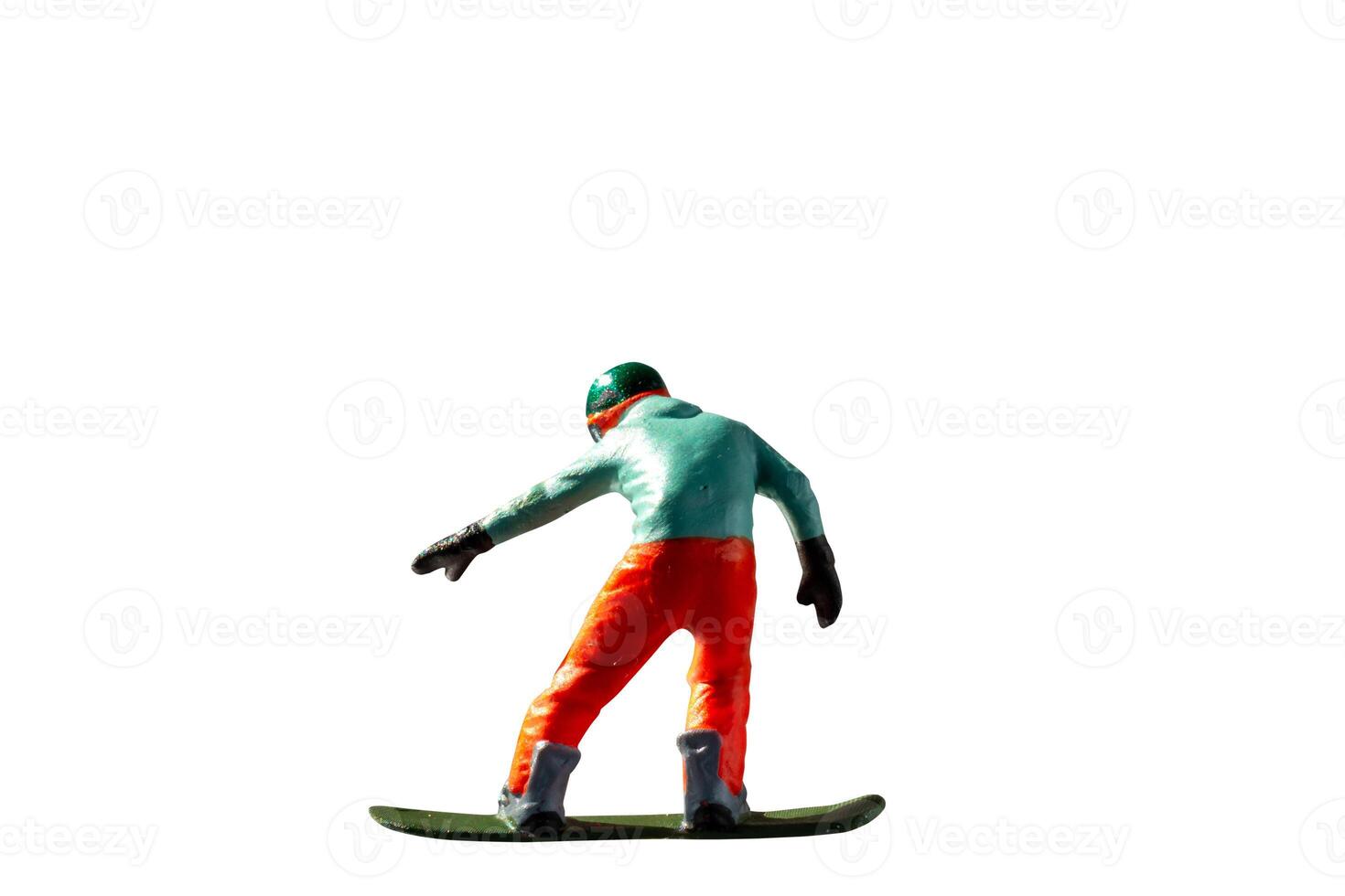 Miniature figurine depicting a snowboarder in mid-motion isolate on white background with clipping path photo