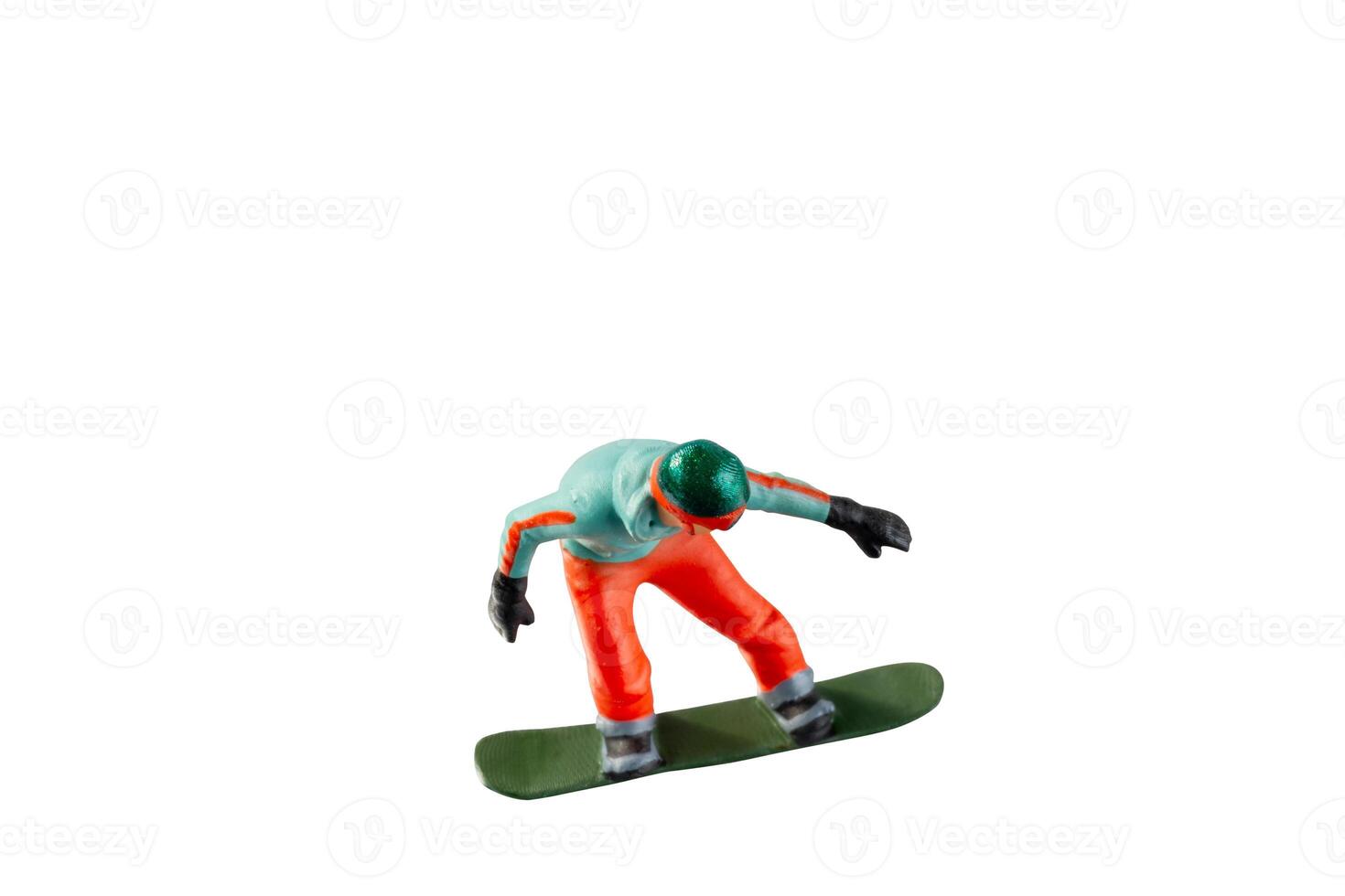 Miniature figurine depicting a snowboarder in mid-motion isolate on white background with clipping path photo