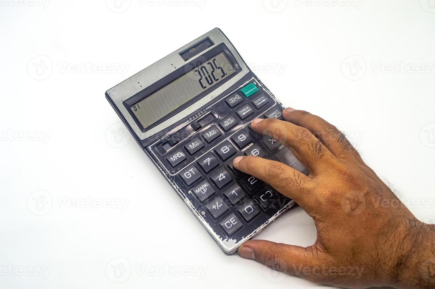 A hand using a calculator displaying the year 2025, symbolizing future financial planning or budgeting. The image highlights the importance of financial foresight photo